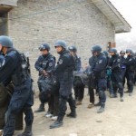 Tibetans’ are forced to bow down as they are taken away by Chinese security forces. (From a Chinese military forum)