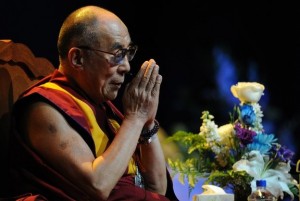 The Dalai Lama greets the audience ahead of a public talk on "Peace of Mind in Troubled Times" in Long Beach on April 21, 2012 in California. AFP 
