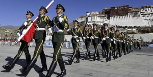 Chinese paramilitary police march during a flag raising ceremony near Potala Palace in Lhasa, capital of Tibet/AP Photo.