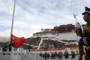 Paramilitary policemen salute the Chinese flag during its raising ceremony to celebrate Tibet's second Serfs Emancipation Day in front of the Potala Palace in Lhasa, Tibet March 28, 2010. Reuters photo